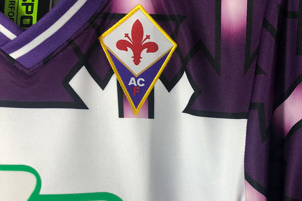 White Fiorentina retro away shirt detail — purple geometric pattern cult design