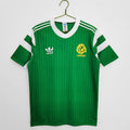 Cameroon 1990 Home retro football shirt hanging in The Retro XI locker room in deep green with red and yellow flag trim