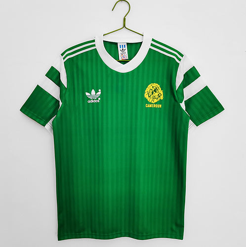 Cameroon 1990 Home retro football shirt hanging in The Retro XI locker room in deep green with red and yellow flag trim